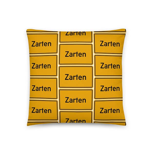 Ein gelbes Kissen mit dem Zarten Basic-Kissen-Logo.