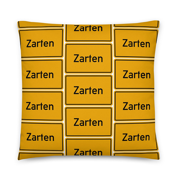Ein gelbes Kissen mit dem Label Zarten Basic-Kissen.