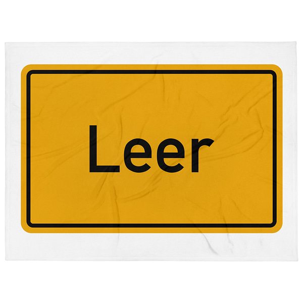 Ein gelbes Verkehrsschild mit der Aufschrift „Leer“ und einer Tagesdecke darauf.