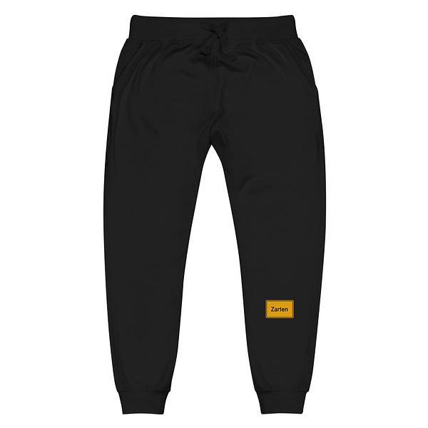 Eine schwarze Unisex-Fleece-Jogginghose mit gelbem Logo darauf.